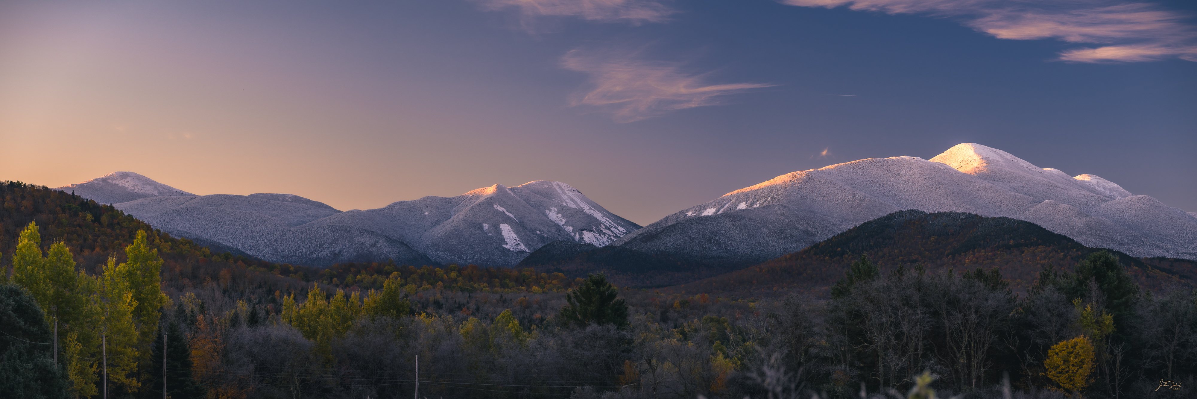 Panoramic Alpine Glow on Snow-Capped High Peaks