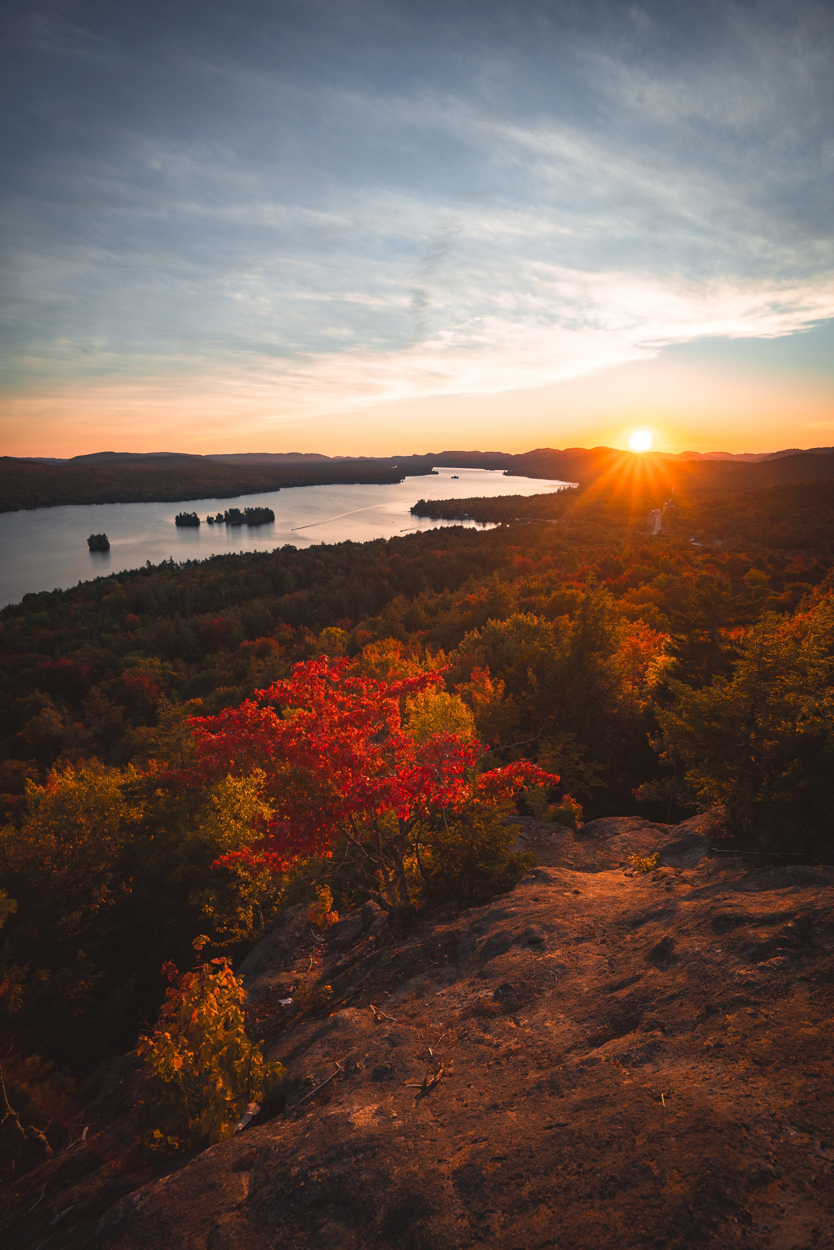 A low sun stretches across Fourth Lake, viewed from Rocky Mountain near Inlet, New York.
