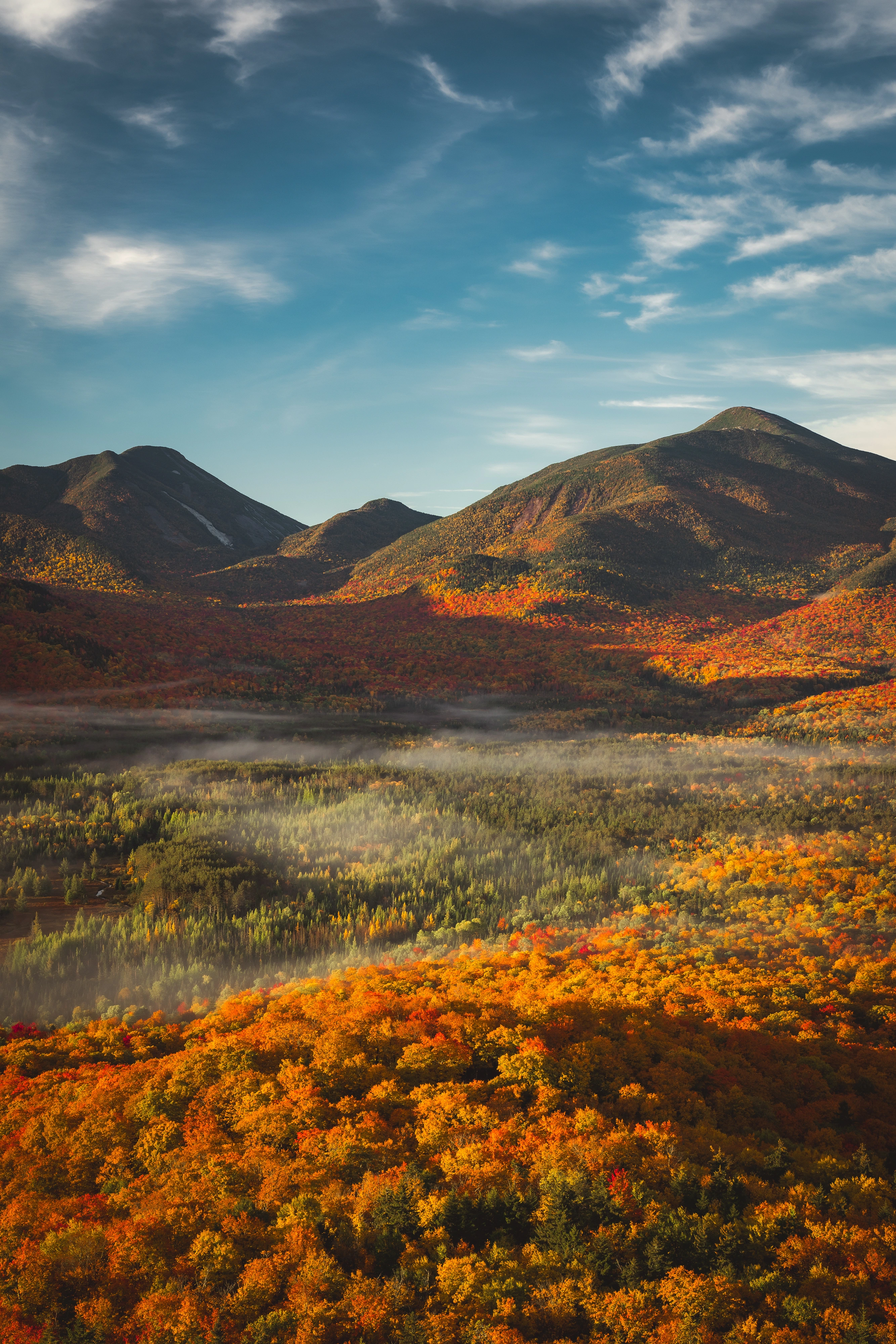 Morning light reaches Mount Colden on the left and the MacIntyre Range on the right. Mount Van Hoevenberg, Adirondack High Peaks, New York.