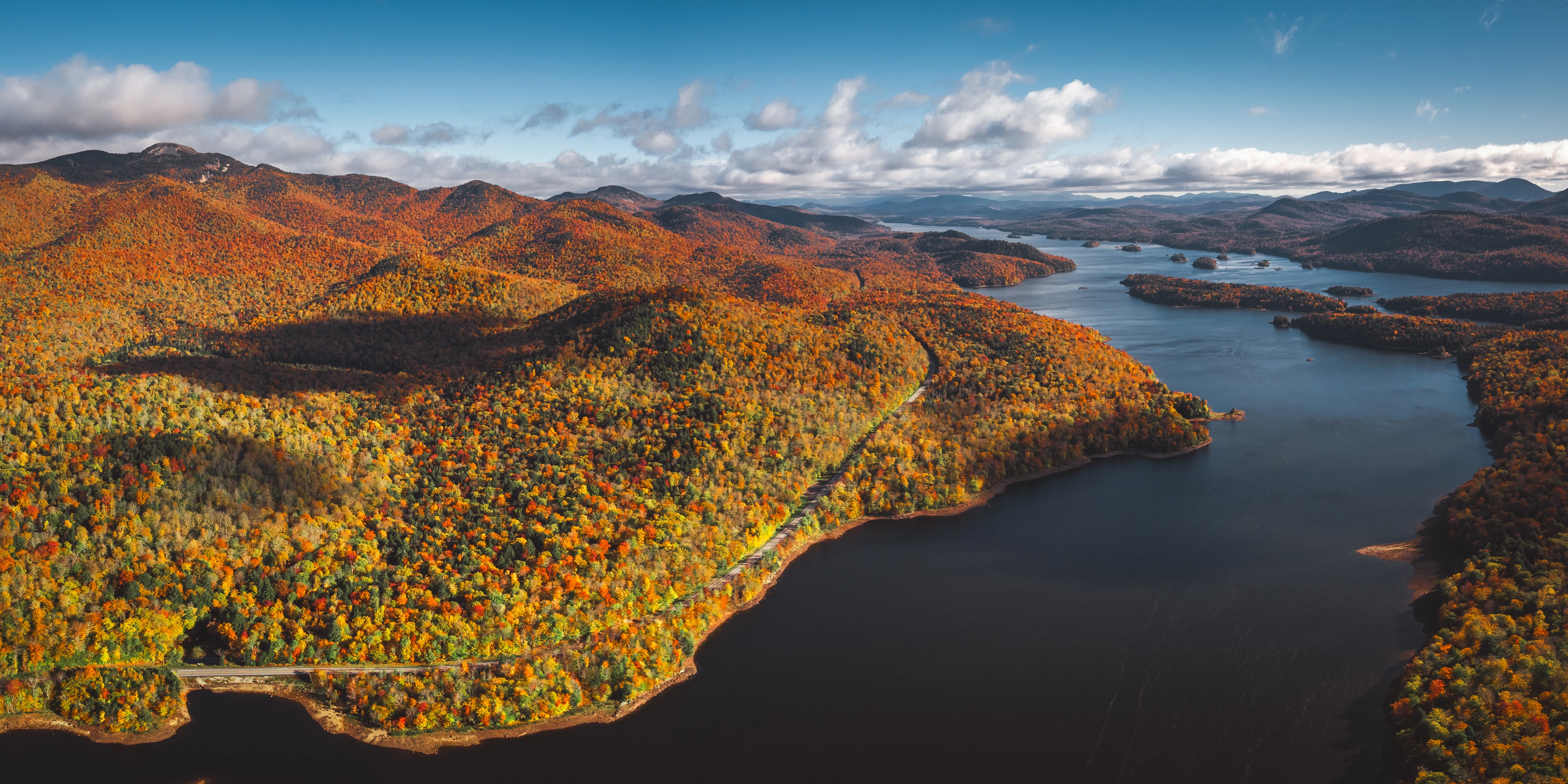 A northern view of Indian Lake follows its winding shoreline through peak fall color. Indian Lake, Adirondacks, New York.