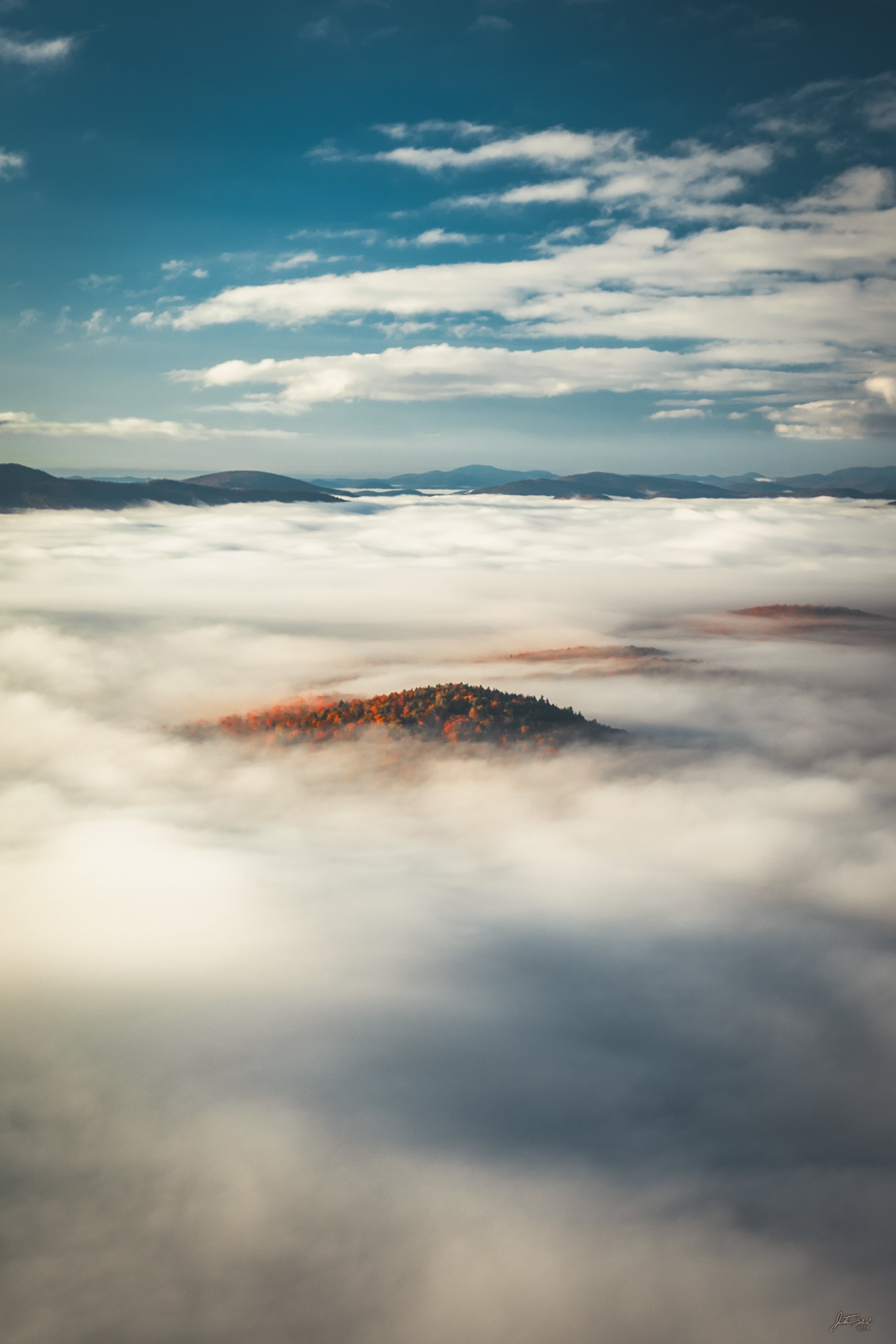 Autumn Island Rising Above the Clouds
